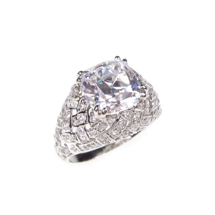 Square cushion cut diamond bombe ring, claw set with a 2.69ct, D VVS2